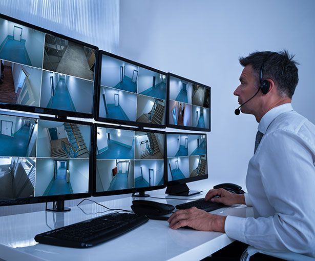 Professional security guard monitoring CCTV cameras