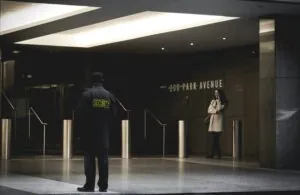 Professional security guard monitoring a building entrance